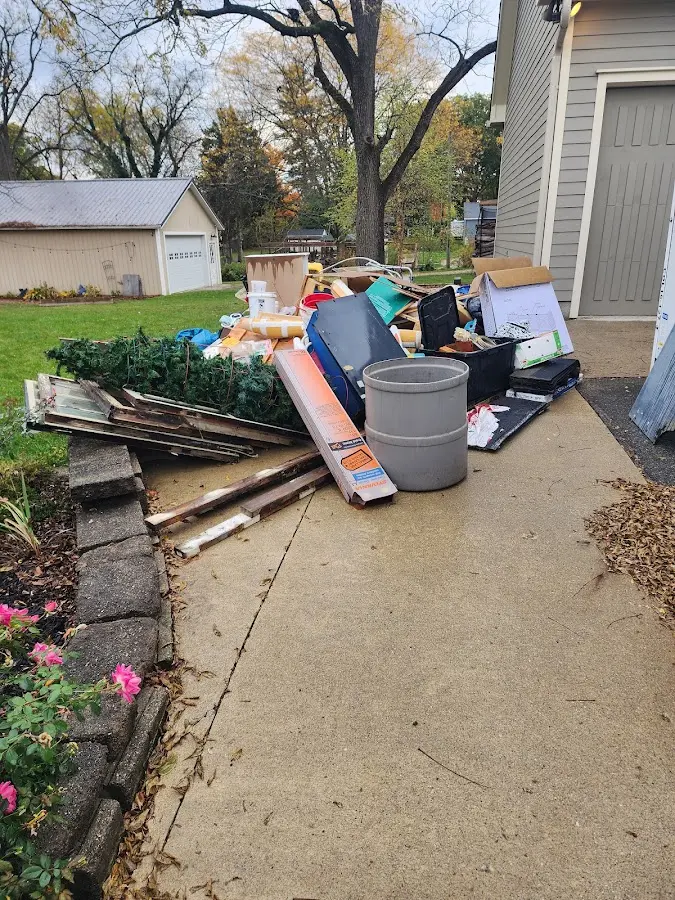 Dumpster being loaded with debris for Residential Dumpster Rental in St. Johns